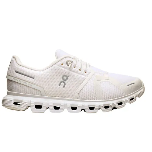 White athletic shoe with a mesh upper, distinctive cushioning, and a unique sole design featuring cut-out sections.