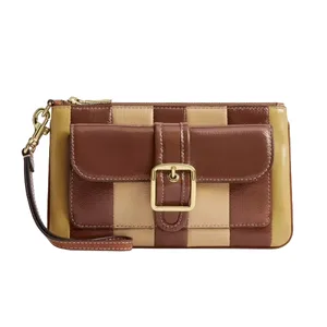 A wristlet clutch featuring a checkered pattern in brown and beige with a front flap pocket and gold buckle detail.