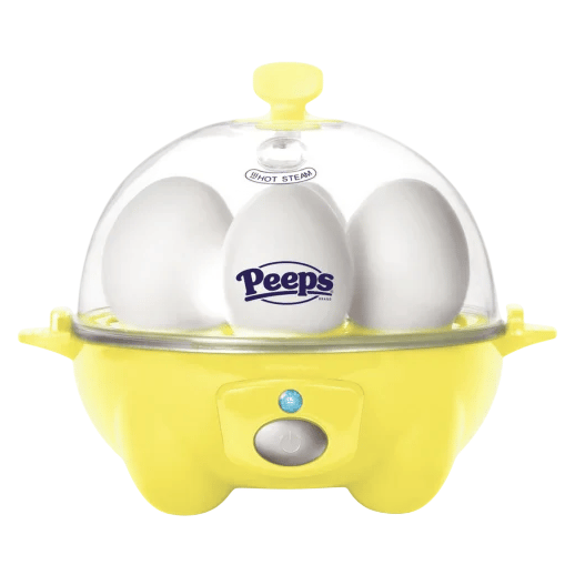 A yellow egg cooker with a transparent lid contains three eggs, one branded with the \“Peeps\“ logo.