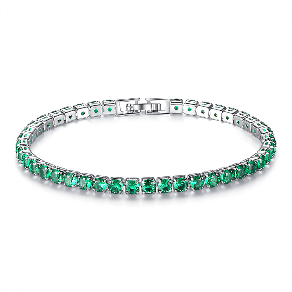 18K gold-plated tennis bracelet featuring vibrant green stones set in a linear pattern, secured with a clasp closure.