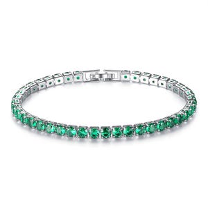 18K gold-plated tennis bracelet featuring vibrant green stones set in a linear pattern, secured with a clasp closure.