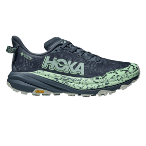 Hoka trail running shoe featuring a GORE-TEX membrane and Vibram outsole, with a blend of dark and light green colors and a textured design.