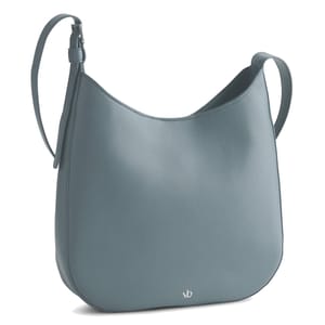 A blue leather shoulder bag with a minimalistic design and an adjustable strap, featuring small \“vb\“ branding near the bottom.