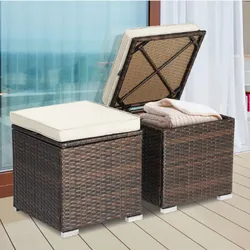 Outdoor storage ottomans with wicker design, featuring cushioned tops and internal storage space. One ottoman is shown open, storing blankets.