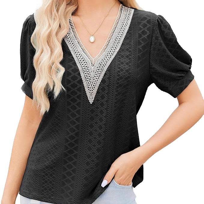 Black puff-sleeve top with a textured pattern and a V-neckline featuring a decorative white lace trim. Worn with light-colored pants, the top includes subtle gathering on the sleeves for a stylish touch.