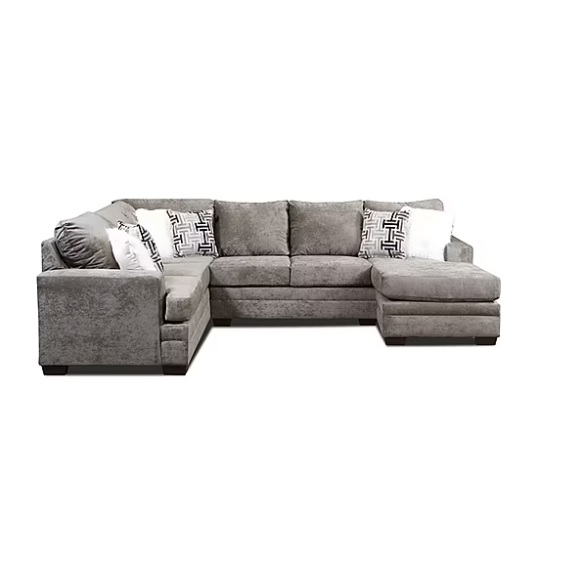 Gray sectional sofa with an L-shape design, featuring a chaise lounge on the right side and several patterned and plain pillows for added comfort.