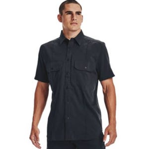 A man is wearing a short-sleeve black button-up shirt with two chest pockets.