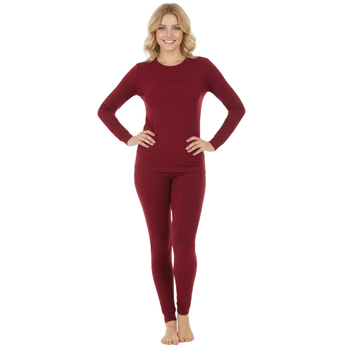 A person is wearing a matching maroon long-sleeve top and bottoms, standing barefoot against a light gray background.