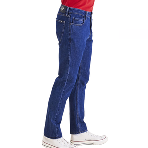 Dockers Jean Cut Pants are classic blue denim with a straight-leg design, featuring five pockets and a mid-rise fit, paired here with white sneakers and a red shirt.