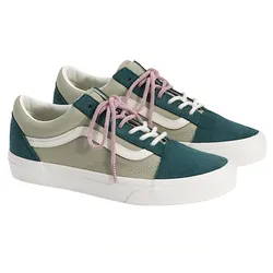 A pair of low-top sneakers featuring a teal and beige color scheme, enhanced with pink and white checkered laces and a white wavy stripe logo on the side.