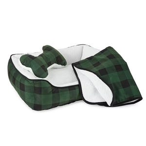 A green and black plaid dog bed with matching bone-shaped pillow and blanket.