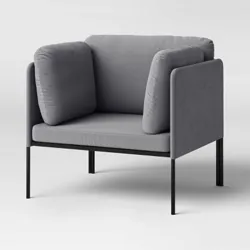 A modern gray armchair with a minimalist design, featuring cushioned sides and backrest on a slim black metal frame.