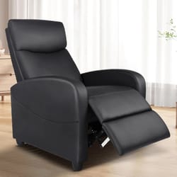 A black recliner chair with a cushioned back, armrests, and an extended footrest positioned in a bright room with wooden flooring.