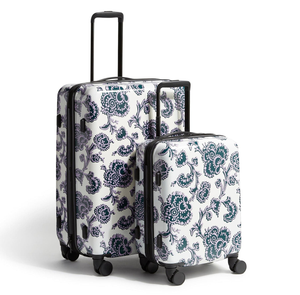 The Vera Bradley Hardside Luggage Set features two suitcases with a floral pattern, one larger and one smaller, both with four wheels and retractable handles for easy maneuvering.
