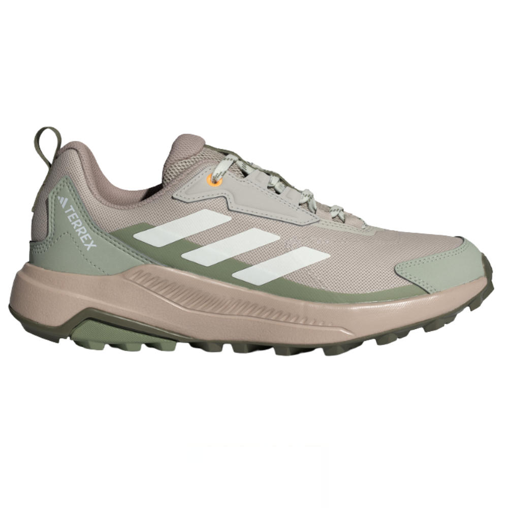 Adidas Terrex hiking shoe with a beige and green color scheme, featuring a rugged sole for improved traction and the signature three stripes in white.