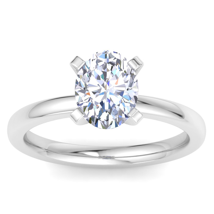 A sleek ring with a central oval-cut diamond, held by four prongs, set on a polished metal band.