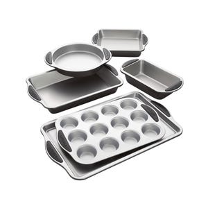 A set of five variously sized metal baking pans, including a round pie dish, a muffin tray, and rectangular baking sheets.