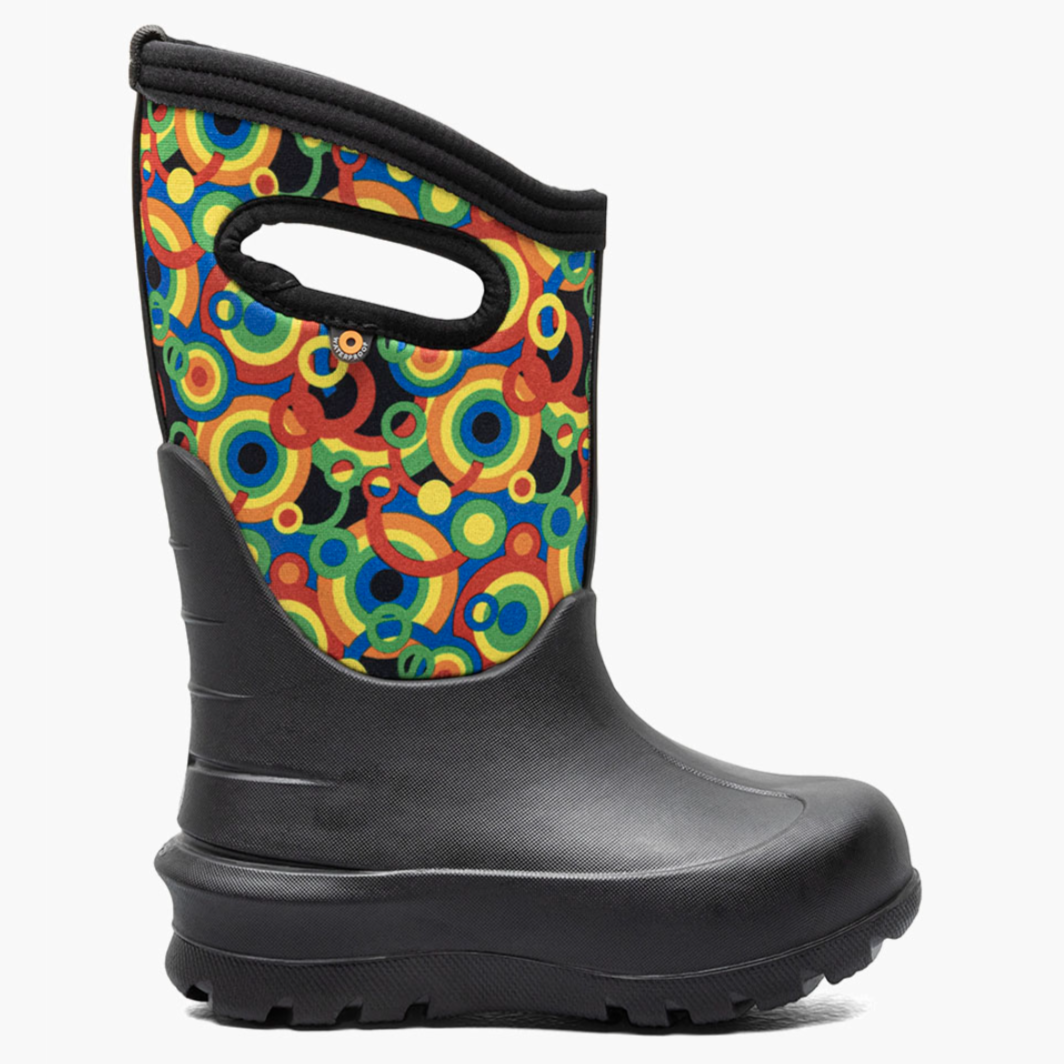A black rubber boot with a brightly colored, circular patterned fabric upper and a handle cutout for easy carrying.