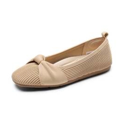 A beige flat shoe with a pleated design and bow detail on the front.