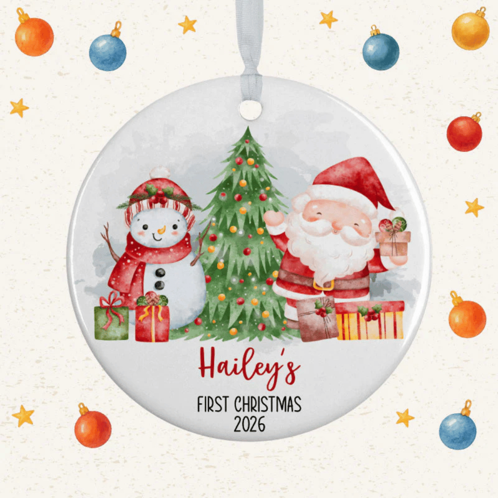 A round ornament featuring Santa, a snowman, and a Christmas tree, with \“Hailey's First Christmas 2026\“ written on it, surrounded by a festive background with stars and baubles.