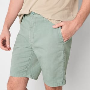 A person wearing light green casual shorts.