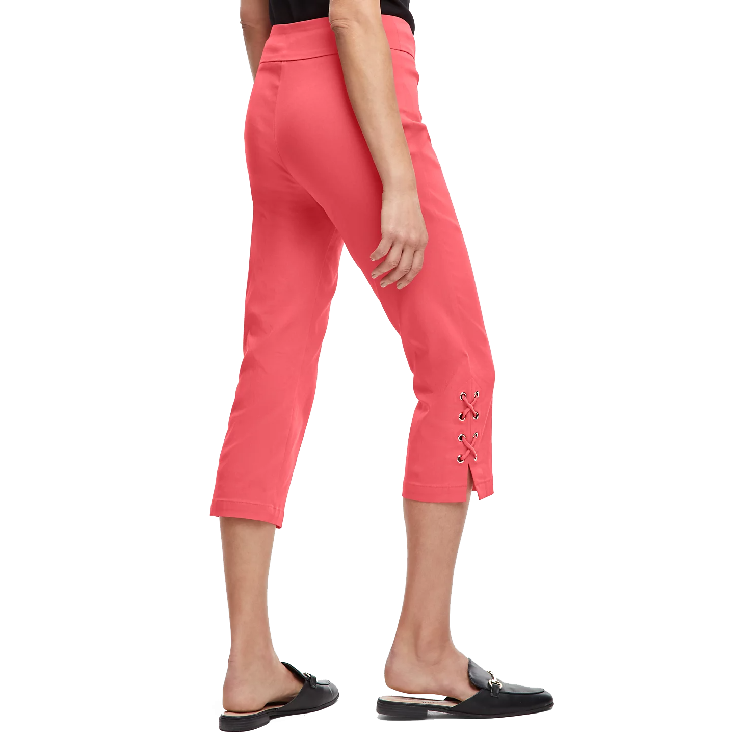 Coral-colored capri pants featuring lace-up details near the hem, paired with black open-back loafers.