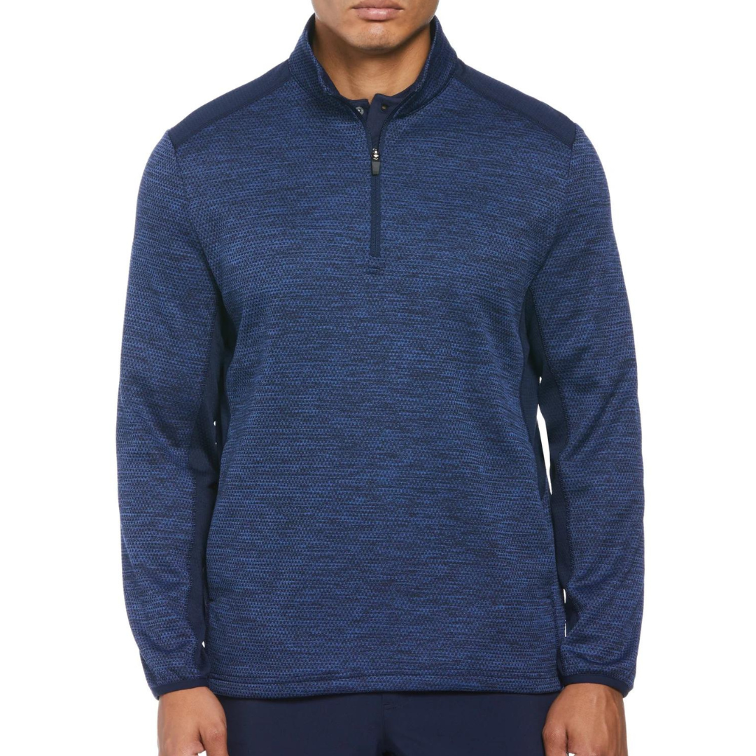 A man wearing a blue, zippered half-pullover with a textured pattern.