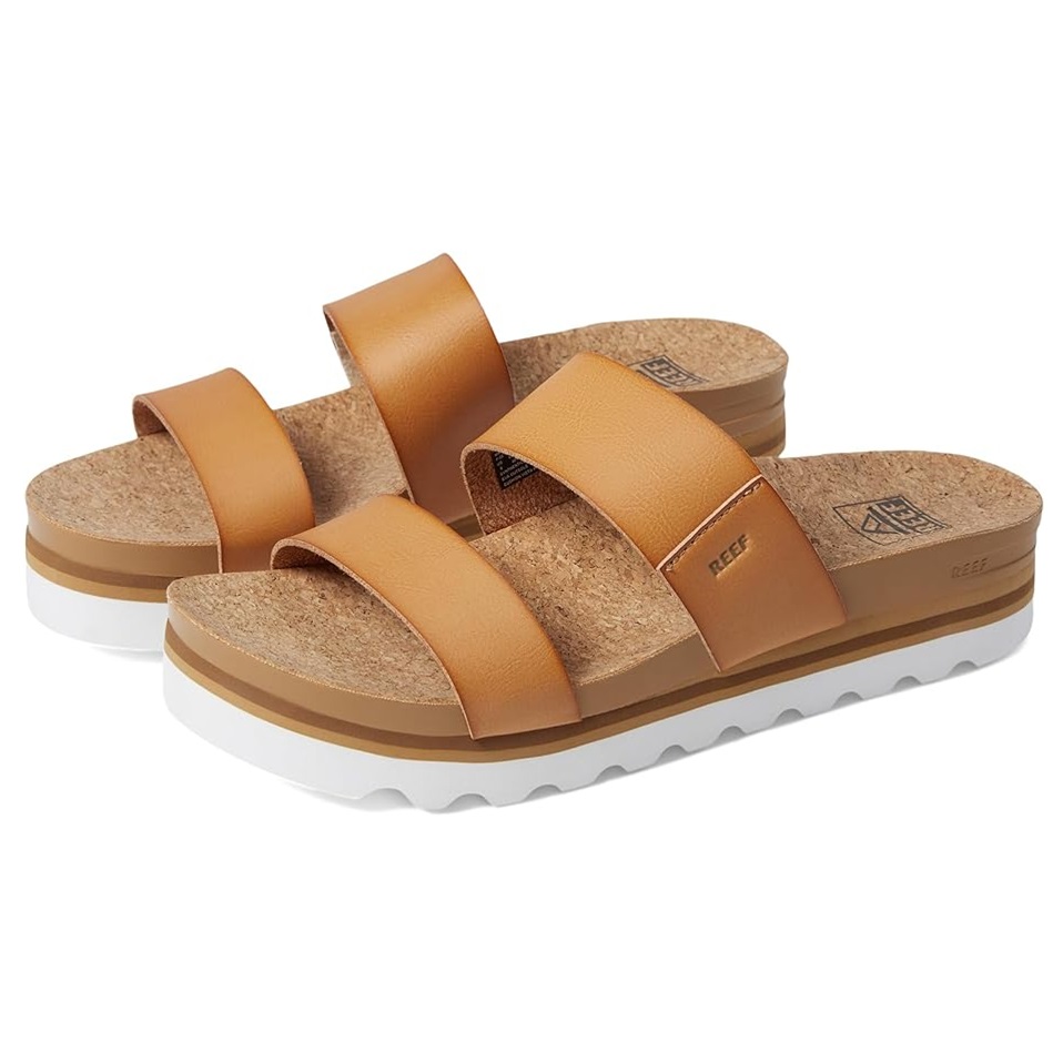 A pair of tan platform sandals with thick crisscross straps and a cork footbed.