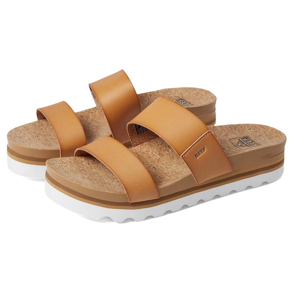 A pair of tan platform sandals with thick crisscross straps and a cork footbed.