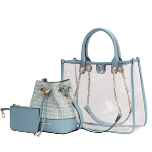 A stylish set featuring a clear tote bag with blue handles and gold chain details, accompanied by a blue and tweed drawstring bucket bag and a small zippered pouch.