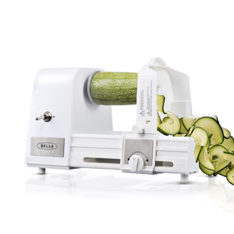 Electric spiralizer slicing a zucchini into spirals.