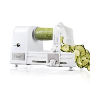 Electric spiralizer slicing a zucchini into spirals.