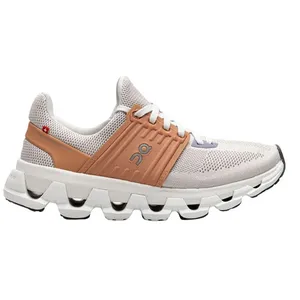 A white and brown athletic shoe with mesh fabric and distinctive cushioned sole, featuring a unique lacing system and a small circular logo on the side.