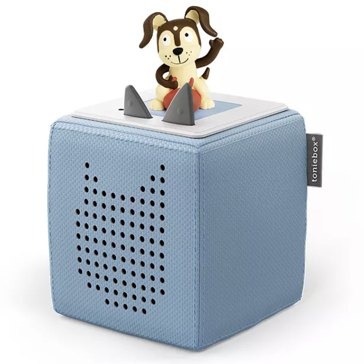 A blue Toniebox audio player with a dog figurine on top, used for playing audio content for children.