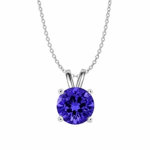 A necklace with a silver chain features a round, deep blue gemstone in a simple pendant setting.