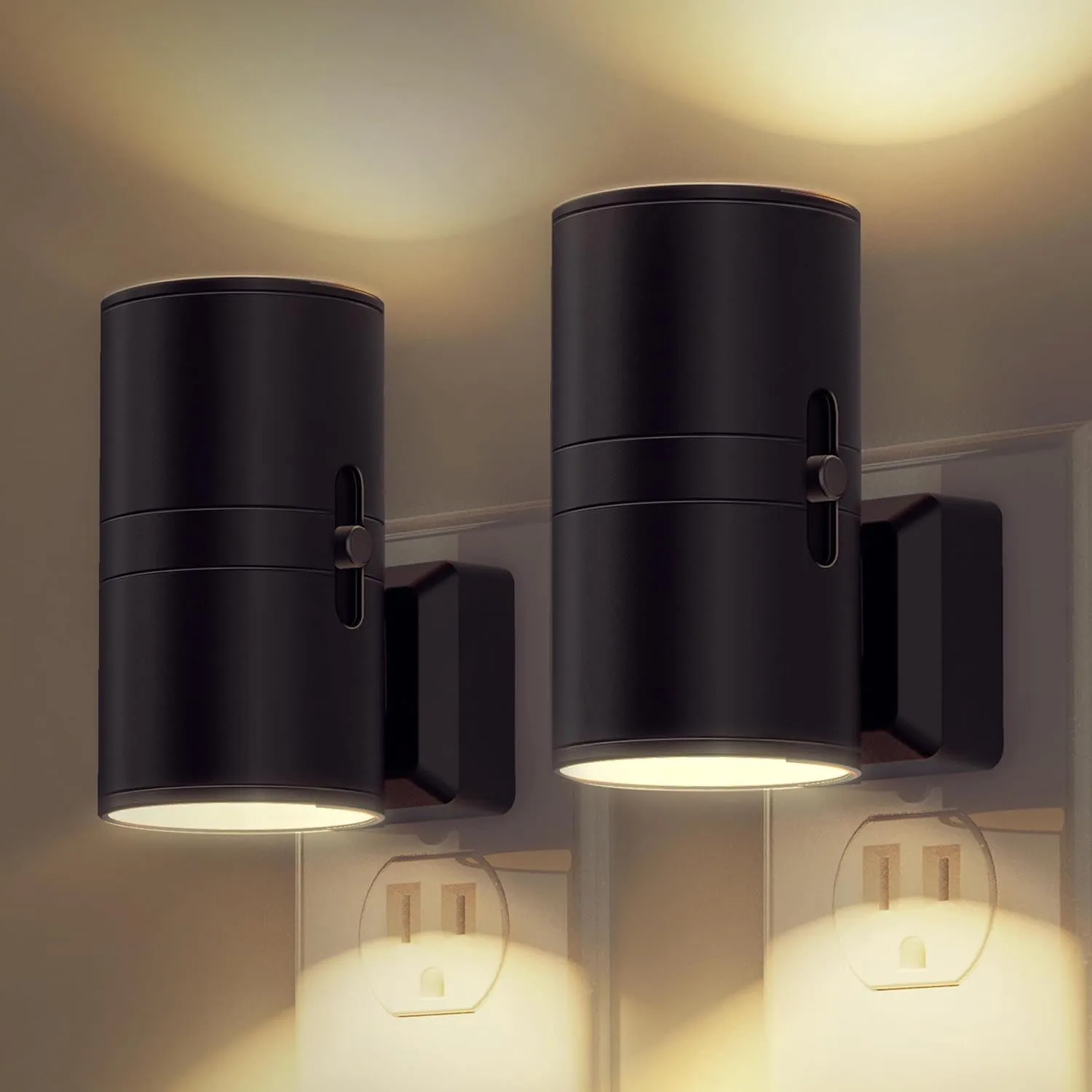 Two black wall-mounted cylindrical LED wall lights illuminate both upwards and downwards, installed above electrical outlets.