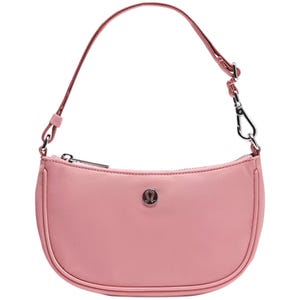 A small pink shoulder bag with a detachable strap featuring metal clips. It has a zipper closure and displays a circular logo emblem on the front.