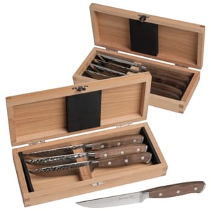 A set of steak knives with wooden handles displayed in open wooden boxes.
