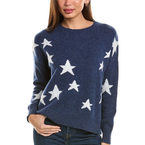A woman wearing a blue crewneck sweater with white stars.