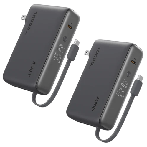 Two Aukey 10,000 mAh portable power banks with attached USB cables and digital displays showing charging status.