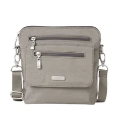 Gray crossbody bag with two front zippered pockets, adjustable strap, and metal hardware accents.