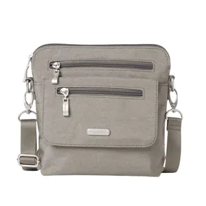 Gray crossbody bag with two front zippered pockets, adjustable strap, and metal hardware accents.