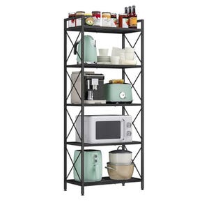 A black metal kitchen rack with five shelves holds jars, bottles, a kettle, a coffee machine, a toaster, a microwave, a mixer, and stacked cooking pots alongside dishes and cups.