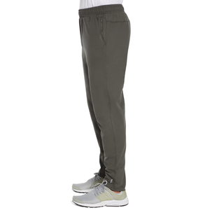Dark green gym pants with an elastic waistband and zippered side pockets. Paired with gray and light green athletic shoes.