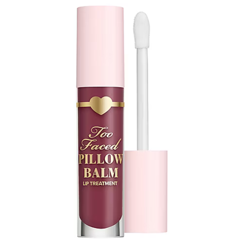 Too Faced Pillow Balm Lip Treatment featuring a maroon shade with a gold heart accent, paired with a light pink applicator.