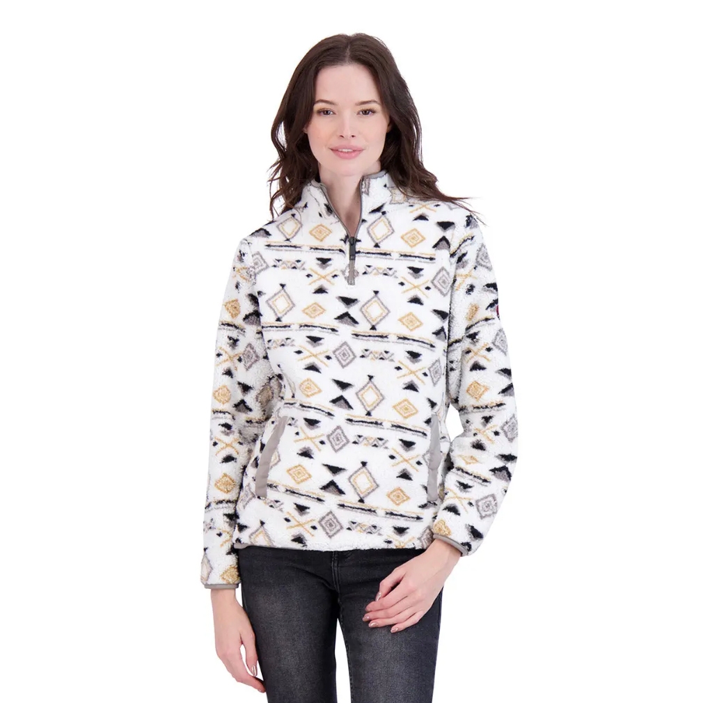 A woman wearing a patterned pullover fleece jacket with a geometric design, featuring a front zipper and side pockets, paired with dark jeans.