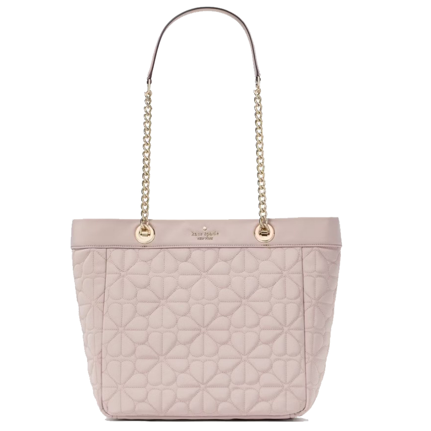 A light pink tote bag with quilted floral patterns, gold chain straps, and a small logo detail at the top center.