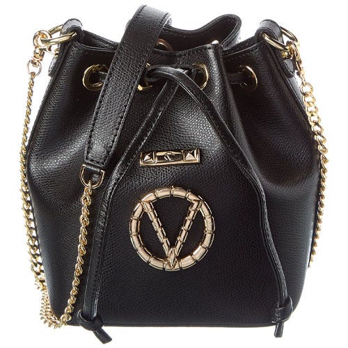 Black bucket bag with gold chain straps and gold circular emblem on front.