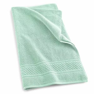 Martha Stewart 100% Cotton Bath Towels are soft, absorbent, and feature a subtle decorative border. They have a fresh, mint-green color and are designed for everyday use.