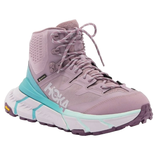 A high-top Hoka hiking shoe in a light purple color, featuring a cushioned sole with teal accents and a Vibram outsole for traction.
